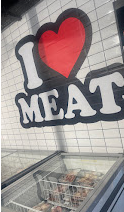 The I Love Meat heart mural painted on the white tiled shop wall
